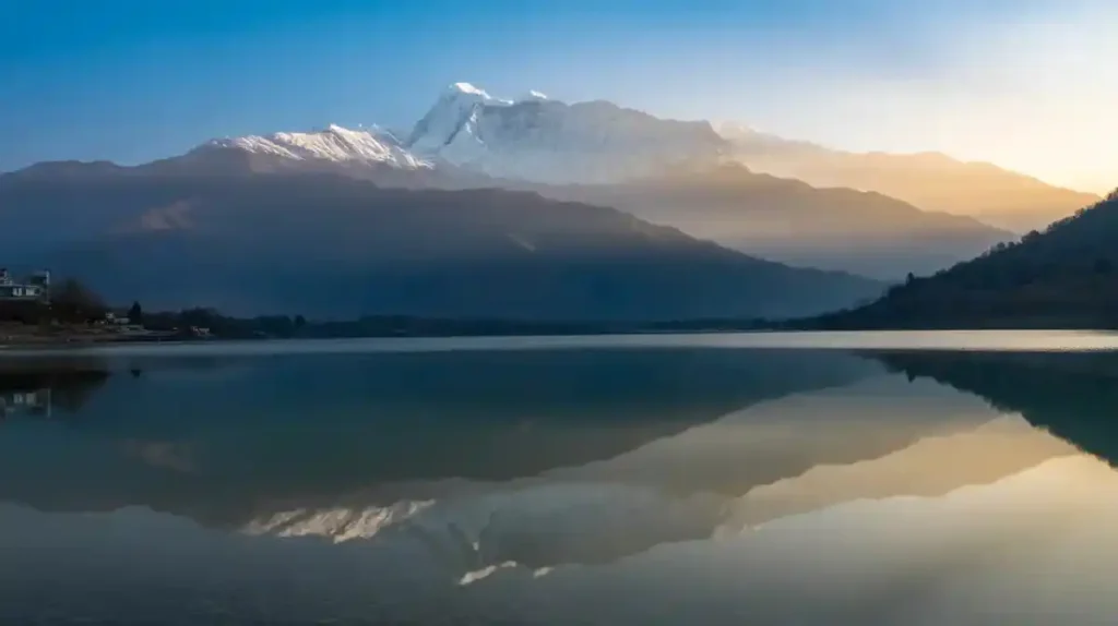 Annapurna range covered in snow reflected in Pokhara's Phewa Lake